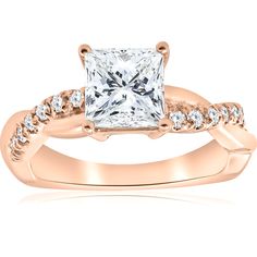 a rose gold engagement ring with a princess cut diamond in the center and side stones