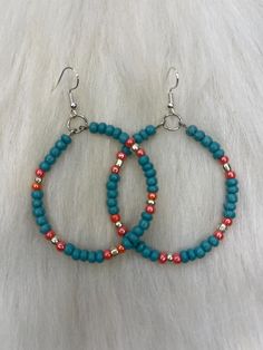 Hi everyone 😊 You are looking at another pair of Pretty Earrings by Audrey, all handmade with love. Handmade Earrings, Turquoise, Peach, Silver Small Beads, Silver Hoop Dangle Earrings. This pair is 3 inches long from top to bottom. And about 2 inches wide. Thank you for looking at my handmade jewelry Turquoise Dangle Hoop Earrings With Colorful Beads, Handmade Small Hoop Turquoise Beaded Earrings, Turquoise Beaded Earrings With Small Hoop, Handmade Turquoise Hoop Earrings With Round Beads, Turquoise Hoop Earrings With Dangling Beads For Gifts, Handmade Orange Hoop Earrings, Turquoise Hoop Earrings With Dangling Beads As Gift, Hoop Dangle Earrings, Henderson Nv