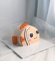 a cake made to look like a fish on top of a white sheet covered table