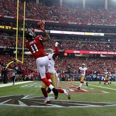 a football player jumping up into the air