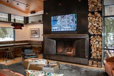 a living room filled with furniture and a fire place in front of a flat screen tv