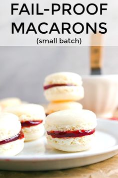 small biscuits with jam on them sitting on a plate