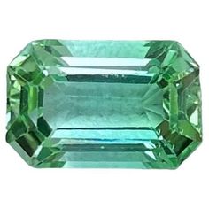 an emerald colored stone is shown on a white background