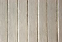 a white wooden wall with vertical slats