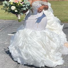 a woman in a wedding dress holding a bouquet