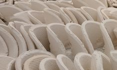 rows of white wicker chairs are lined up