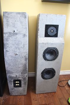 two concrete speakers sitting next to each other