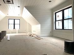 an empty room with white walls and wood floors