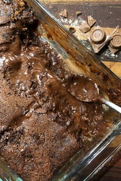 a chocolate dessert in a glass dish on a wooden table