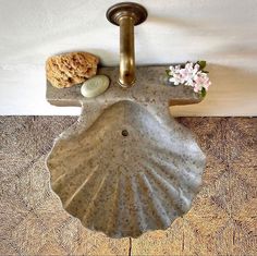 a bathroom sink sitting on top of a wooden floor next to a wall mounted faucet