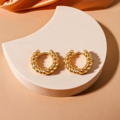 Make a bold statement with the Twist Rope Design Hoop Earrings. These 14K gold chunky earrings feature a captivating spiral twisted design, offering a fresh take on traditional hoops. Perfect for women who enjoy unique and stylish accessories, these dainty round hoops add a touch of glamour to any outfit. Whether paired with casual wear or elegant attire, these earrings are a fantastic gift choice that embodies both sophistication and charm. Minimalist Twisted Gold Hoop Earrings, Elegant Twisted Gold Plated Hoop Earrings, Modern Twist Gold Plated Hoop Earrings, Twisted Gold Plated Yellow Gold Hoop Earrings, Twisted Gold Plated Hoop Earrings, Gold Round Earrings, Chunky Earrings, Elegant Attire, Rope Design