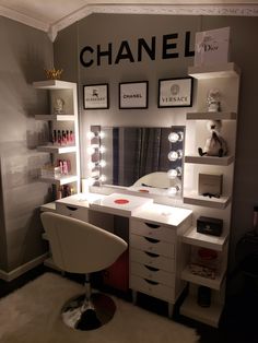 a room with a vanity, mirror and lights on the wall next to a chair