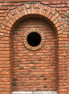 a brick wall with a hole in the middle