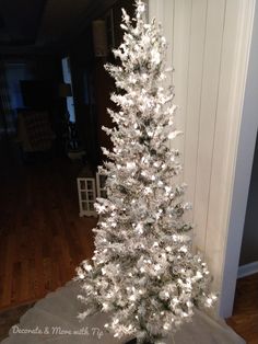 a white christmas tree in a living room