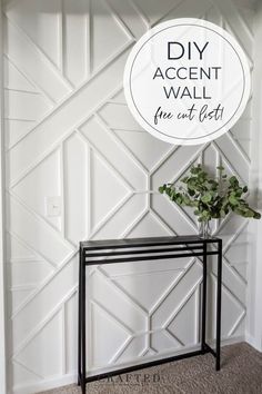 a black and white table with a plant on it in front of a wall that says diy accent wall