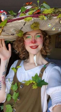 a woman with glasses and a hat on her head