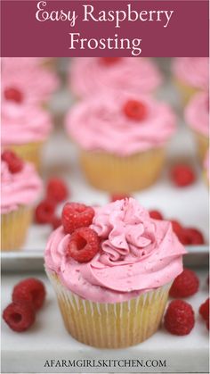 raspberry frosting on top of cupcakes with fresh raspberries