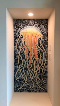 a bathroom with a jellyfish mosaic on the wall