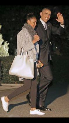 a man and woman walking down the street