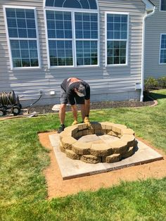 a man working on an outdoor fire pit