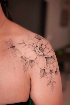 a woman with a flower tattoo on her shoulder