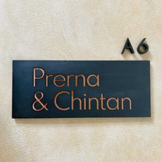 there is a sign that says prerna and chintan on the side of a building