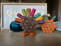 a turkey made out of colored pencils sitting on a table next to other items