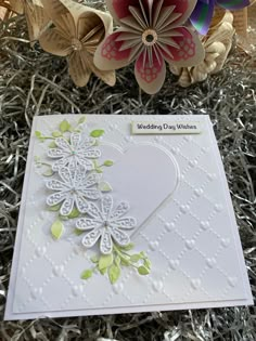 a close up of a greeting card with paper flowers in the shape of a heart