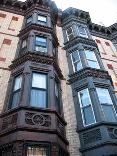 a tall building with lots of windows next to a street