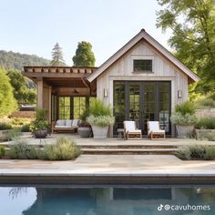 a house with a pool in front of it and lots of greenery on the outside