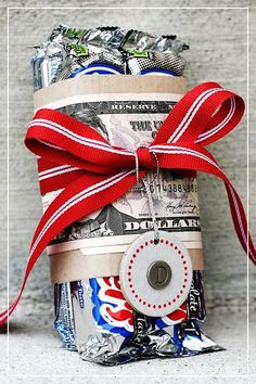 a stack of money wrapped in red, white and blue ribbon with a button on it