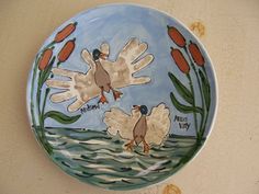 a painted plate with two birds on it