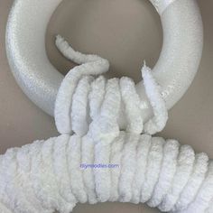 white yarn wrapped around an object in a bowl