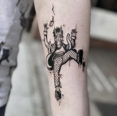 a woman's leg with a tattoo on it that has an image of a man in polka dots