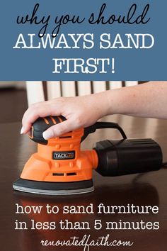 an orange sander sitting on top of a wooden table