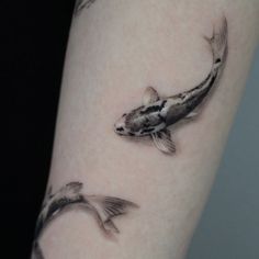 two koi fish are shown on the right arm and left leg, both with black spots