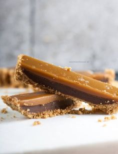 two pieces of peanut butter and chocolate on a white surface