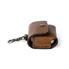 A stylish and convenient accessory. The leather case clips easily to a work or travel bag to keep your headphones close, whether you're working in a busy coffee shop, catching up on podcasts on your commute, or logging some time at the gym. Brown Travel Bag With Key Clip, Functional Brown Everyday Cases, Modern Brown Cases For Everyday Use, Modern Brown Everyday Cases, Functional Brown Cases For Everyday Use, Portable Leather Cases For Personal Use, Modern Brown Cases For Daily Use, Busy Coffee Shop, Airpods Cases