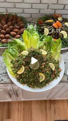 a salad on a plate with lettuce and carrots in the background at a buffet