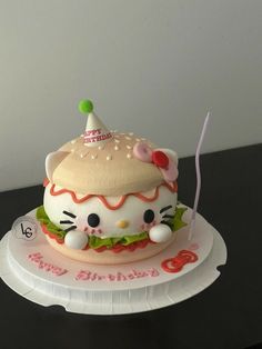 a hello kitty birthday cake sitting on top of a plate