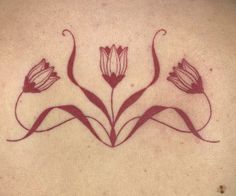 the back of a woman's neck with flowers drawn on it