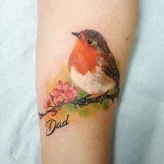 a small bird sitting on top of a branch with the word dad written in it