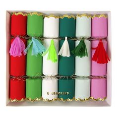 a box filled with lots of different colored candles