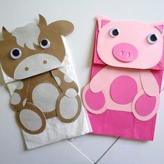 two paper bags with animals on them and one is pink, the other has brown