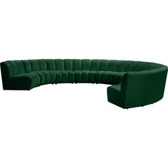 a large green couch sitting on top of a white floor