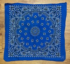 a blue bandana on a wooden floor