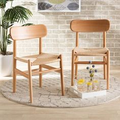 two wooden chairs sitting on top of a rug