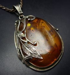 HUGE VINTAGE BALTIC AMBER STERLING SILVER PENDANT with CHAIN DESCRIPTION:  This is a magnificent specimen of Baltic amber set in a sterling silver frame, with applied leaves and scrolls. A thick and heavy 18" twisted sterling silver rope chain accompanies the pendant. This awesome pendant will be a valuable addition to your collection of fine vintage jewelry. MEASUREMENTS:  Chain measures 18" and weighs 15.8g Pendant measures 3 1/4" x 1 3/4" and weighs 34.7g TOTAL WEIGHT:  50.5 grams STERLING: Amber Jewelry Vintage, Pin Pendant, Amber Jewelry, Wedding Jewellery Necklace, Rope Chain, Silver Frame, Wedding Necklace, Vintage Sterling Silver, Sterling Silver Pendants