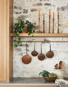 pots and pans are hanging on the wall