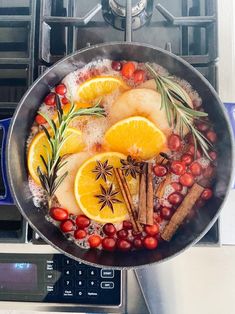 a pan filled with fruit and spices on top of a stove